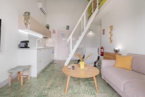 a living room with a couch and a table at Raízes 22 - Apartamento 5 in Puebla de Don Fadrique