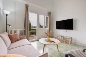 a living room with a couch and a table at Raízes 22 - Apartamento 5 in Puebla de Don Fadrique