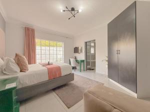 a bedroom with a bed and a large window at Amoris on Anderson in Pretoria +33 photos