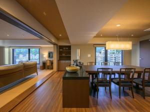 a kitchen and dining room with a table and chairs at Atami Hotel Nagisakan in Atami