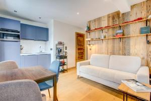 a living room with a white couch and a table at Edelweiss Lodge in Morzine +11 photos