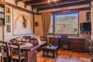 a living room with a table and a kitchen with a view at Terra Minoika Boutique Resort in Kato Zakros +78 photos