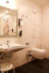 a bathroom with a sink and a toilet at Hotel im Ried in Donauwörth +49 photos