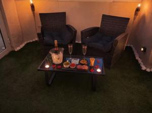 a living room with a table with food and wine glasses at Suite avec Jacuzzi - Clim - Terrasse - Wi-Fi in Agde +5 photos