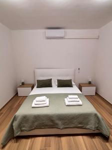 a bedroom with a bed with two towels on it at De Chri House in Cisterna di Latina