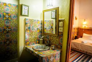 a bathroom with a sink and a mirror at Riad Le Cheval Blanc in Safi +71 photos