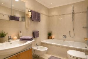 a bathroom with a tub and a toilet and a sink at Residence Bondì in Colfosco +63 photos