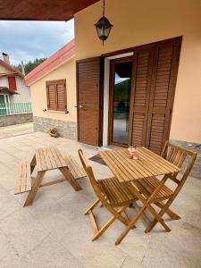 a wooden table and two chairs on a patio at Casa dello Sciatore Lorica in Lorica +45 photos