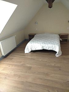 a bedroom with a bed in a attic at Ker Louwen chambre d' hôte in Corseul