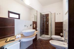 a bathroom with two toilets and a sink and a shower at Borgo Del Principe in Zambrone +86 photos