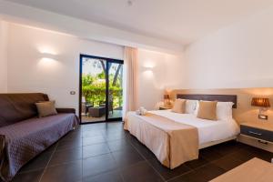 a hotel room with a bed and a couch at Borgo Del Principe in Zambrone