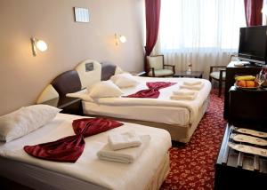 a hotel room with two beds and a television at Akyuz Hotel in Ankara +27 photos