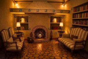 a living room with two chairs and a fireplace at Hotel & Spa La Salve in Torrijos