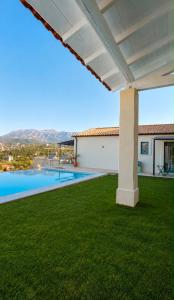 a view from the backyard of a villa with a swimming pool at Kalesma Himare in Himare