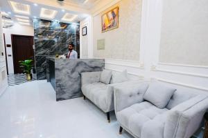 a living room with two couches and a bar at Hotel Haven Lahore in Lahore