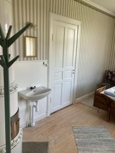 a bathroom with a sink and a mirror at STF Tre Björnar B&B in Älvdalen +29 photos
