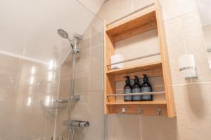 a bathroom with a shower with wine bottles at Critchlow Cottage in Buxton +43 photos