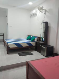 a bedroom with a bed and a dresser in it at Yala Villa Harmony in Debarawewa