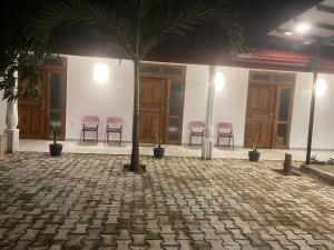 a group of pink chairs in a building at Yala Villa Harmony in Debarawewa