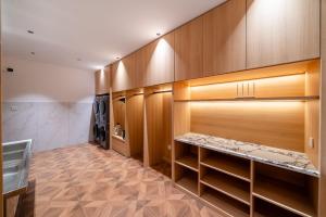a walk in closet with wooden cabinets and a sink at Q.pavilion hotel in Baihe