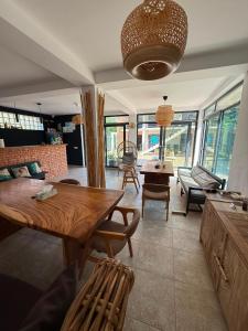 a living room with a wooden table and chairs at Smochin Vama Veche Adults Only in Vama Veche
