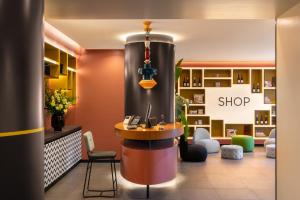 a lobby of a shop with a table and chairs at Aparthotel Colombo Roma in Rome