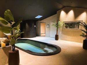 a swimming pool in a room with potted plants at Hôtel Ancre Marine & Spa Thalgo *** in Noirmoutier-en-l'lle +41 photos