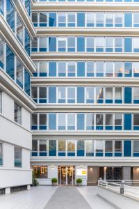 an external view of a building with blue windows at Aparthotel Colombo Roma in Rome