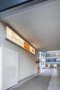 a hallway of a building with a sign on the wall at Aparthotel Colombo Roma in Rome
