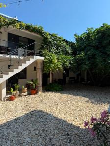 a house with a staircase and a gravel yard at Smochin Vama Veche Adults Only in Vama Veche