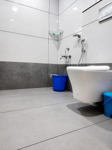 a bathroom with a toilet and a sink and a shower at Birdwing Cottage, Munnar in Munnar +88 photos