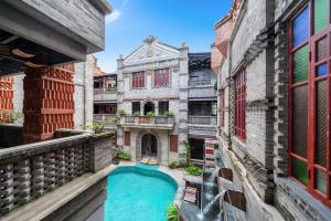 an old building with a swimming pool in a courtyard at Q.pavilion hotel in Baihe