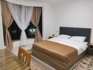 a bedroom with a large bed and a window at Lavanda Beach Resort in Abū Rudays +12 photos