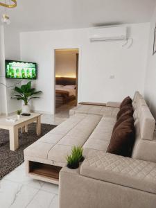 a living room with a couch and a tv at Lavanda Beach Resort in Abū Rudays