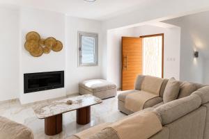 a living room with a couch and a tv at Villa Celestia in Neo Chorio
