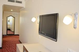a flat screen tv hanging on a wall at Akyuz Hotel in Ankara