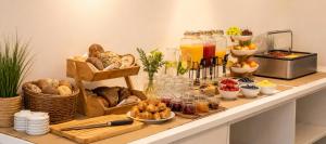 a breakfast buffet with bread and other food on a counter at Motel Smart in Bogen
