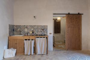 a kitchen with a sink and a counter with towels at Villa Salinara in Marsala +142 photos