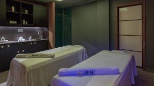 a room with two beds and a sink at MiM Sitges member of Meliá Collection in Sitges