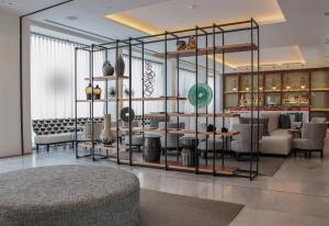 a lobby with a table and chairs in a room at MiM Sitges member of Meliá Collection in Sitges