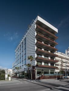 a tall building on a city street at MiM Sitges member of Meliá Collection in Sitges