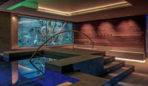 a lobby with a large aquarium in a building at MiM Sitges member of Meliá Collection in Sitges +39 photos