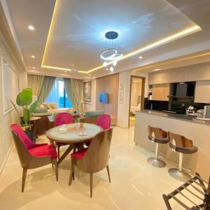 a dining room and living room with a table and chairs at Park Ridge Hotel Serviced Apartments - One Bedroom Apartment in Murree
