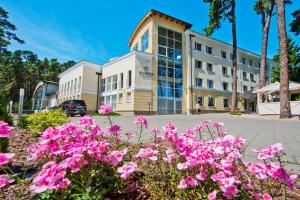 a building with pink flowers in front of it at Marena Wellness & Spa in Międzywodzie +66 photos