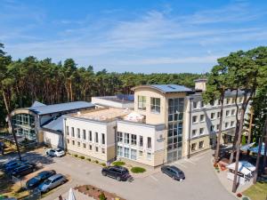 an aerial view of a building with a parking lot at Marena Wellness & Spa in Międzywodzie