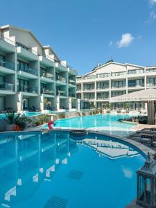 an image of a swimming pool in front of a hotel at Residence 222 Hisarönü in Oludeniz
