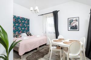 a room with a bed and a table and chairs at Pokoje w Starej Karczmie - Free Parking - by Upstairs in Liszki