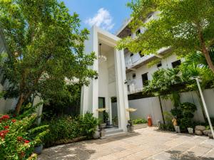 an exterior view of a building with trees and flowers at YUSETH Private Villa in Phumi Ta Phul