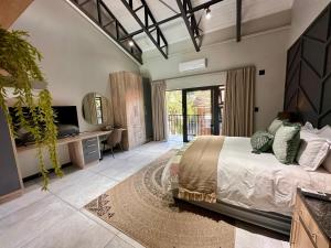 a bedroom with a large bed and a television at Fairview Guest House Executive in Hartswater