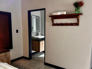 a bathroom with a mirror and a sink at Fairview Guest House Executive in Hartswater +45 photos